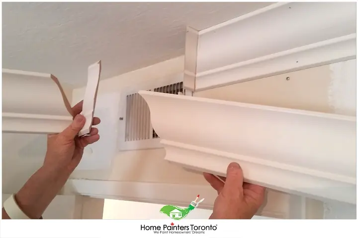 Painter Installing Crown Moulding