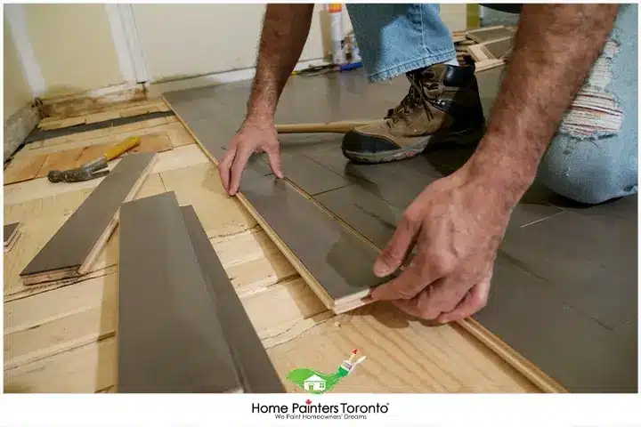 painter installing hardwood floors