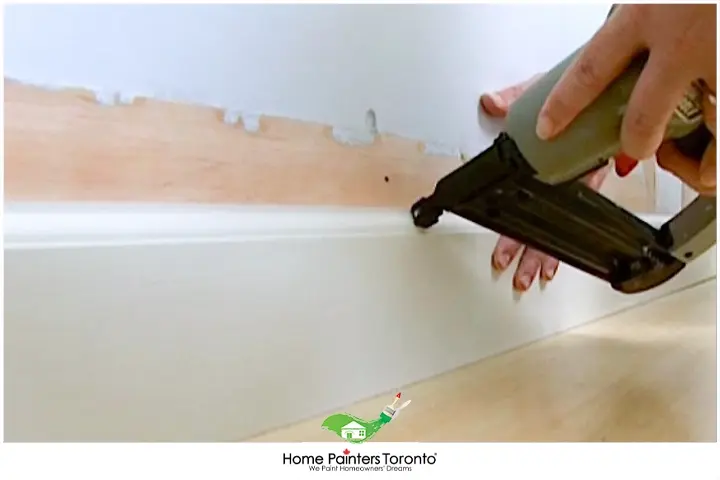 Painter Repairing Baseboards