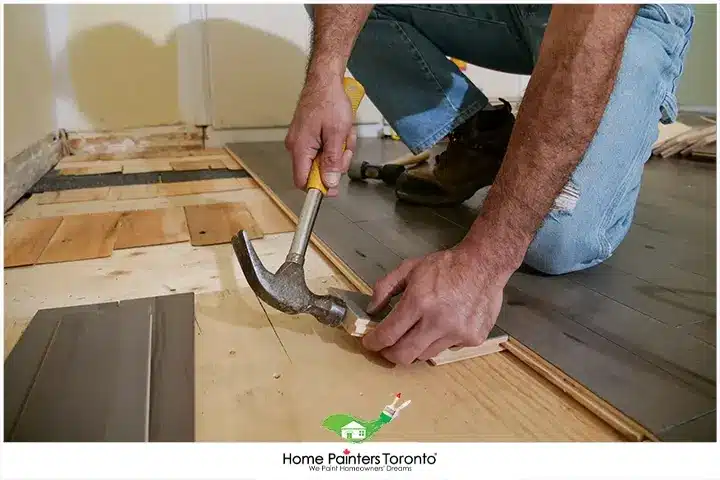 Painter Repairing Hardwood Floors