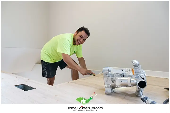 Painter Repairing Laminate Flooring