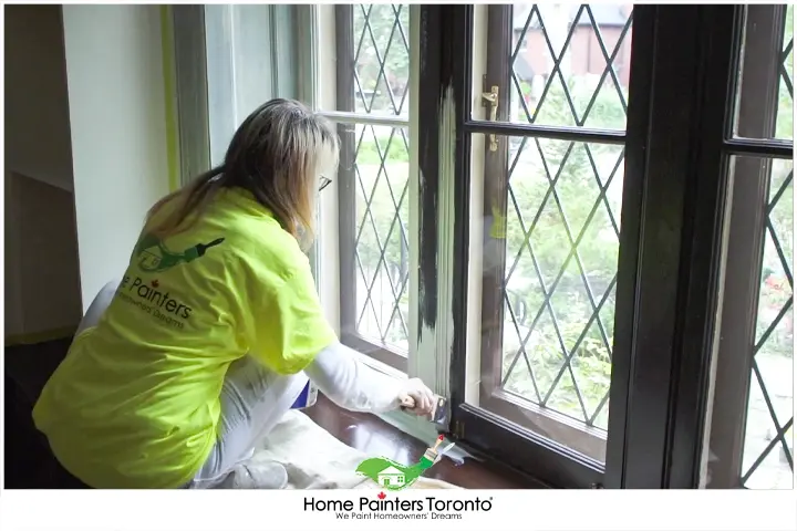 painter painting the window casings