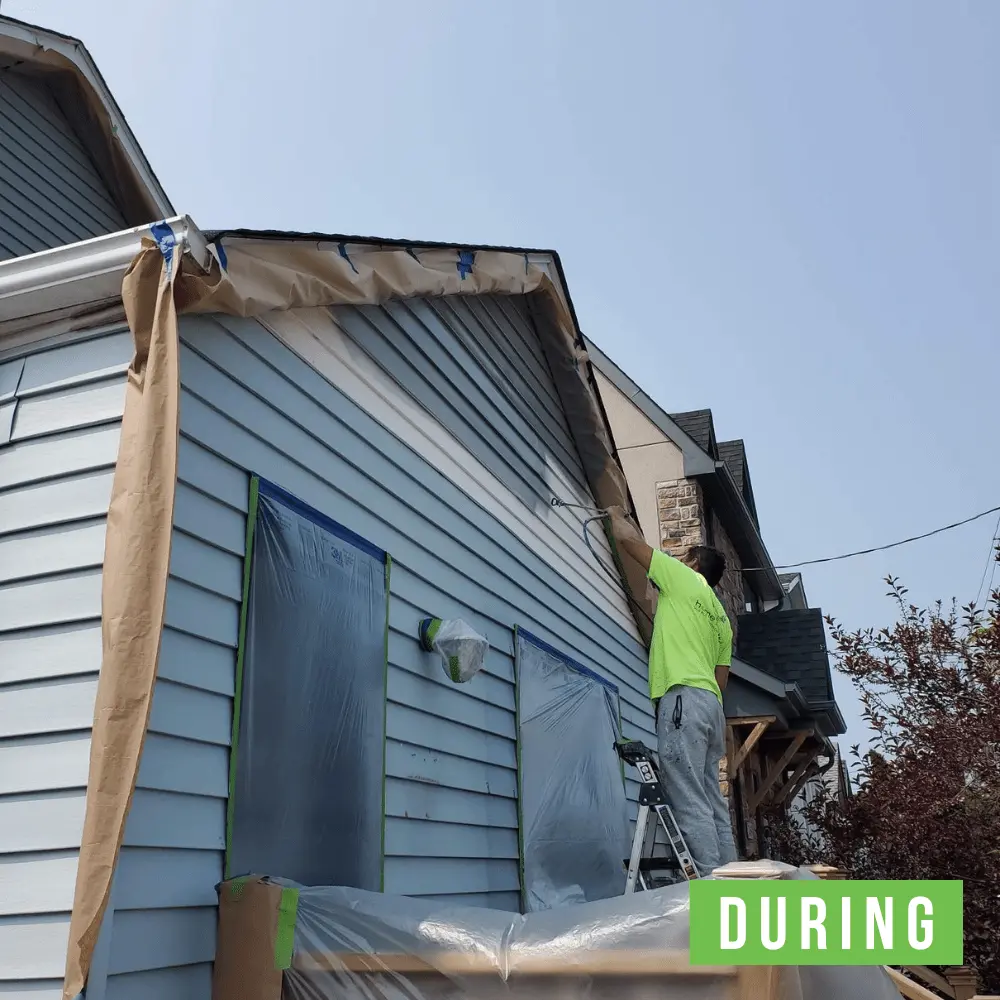 Professional exterior painting crew applying urethane modified acrylic paint on vinyl siding in Mississauga or Brampton GTA showing flexible coating designed for panel expansion